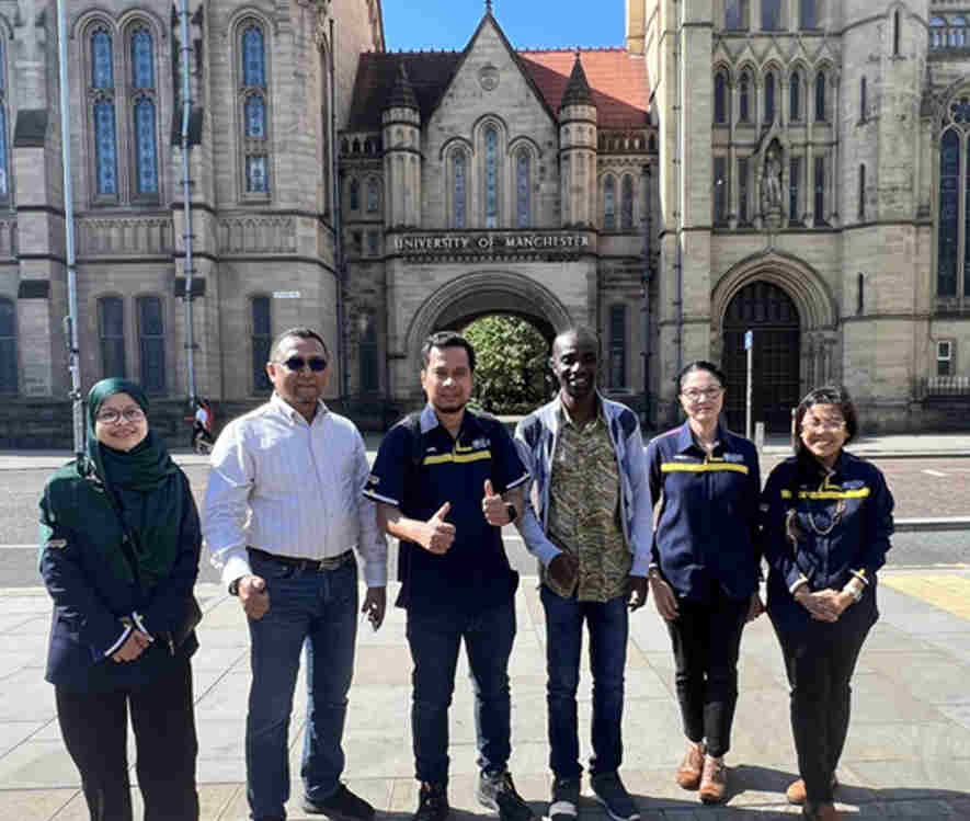 People wearing hard harts at an construction site and appearing at the University of Manchester