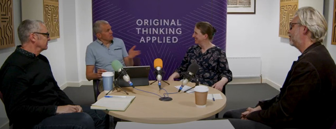 Image of Professor David Fishwick, Professor Sheena Johnson and Professor Martie van Tongeren sitting around a table talking with Jim Pendrill about the PROTECT core study.