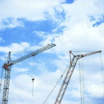 A construction site with a crane, representing the importance of safer structures and enhanced safety standards in the built environment